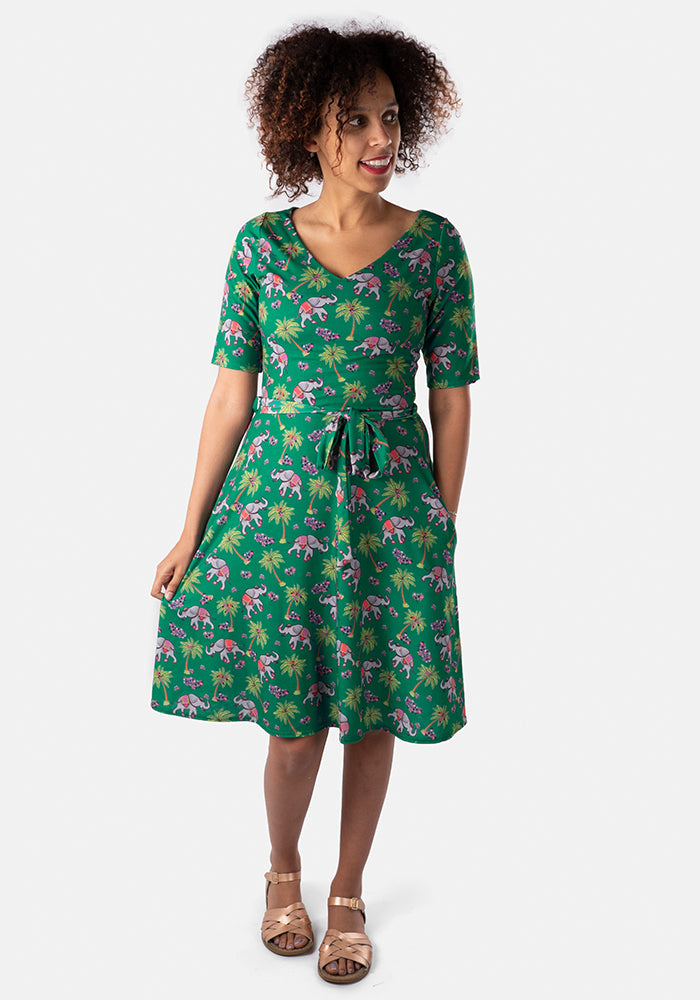 A full length image of Tantor dress on model, Cherish. Tantor – Green Elephant Dress [Flat] which is made up of Jersey Fabric, ½ Sleeve, Flat Waist, V Neck, Green Ground, Fabric Belt.